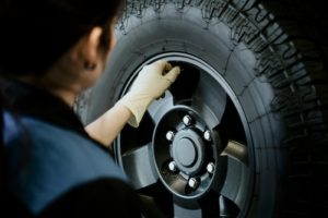 auto mechanic replacing car tires