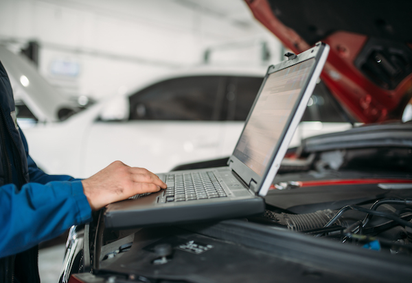 car diagnostic done by man at computer