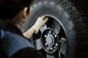 auto mechanic checking car tire information