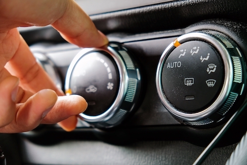 man adjusting car ac settings