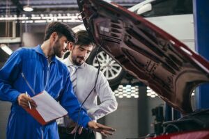 auto mechanic discussing auto diagnostics with a customer